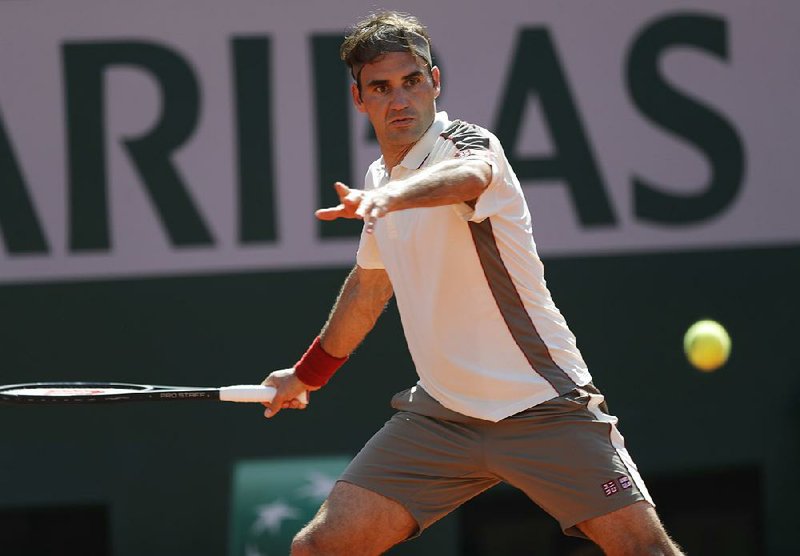 Roger Federer of Switzerland makes a return during his 6-3, 6-1, 7-6 (8) victory over Norway’s Casper Ruud on Friday at the French Open in Paris.
