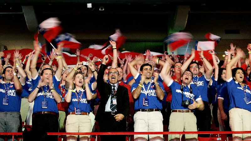 Walmart employees from Chile cheer from their seats in Bud Walton Arena during the 2009 Walmart shareholders meeting in Fayetteville. Analysts will watch during the week for any clues Walmart may give about its direction in the year ahead. 