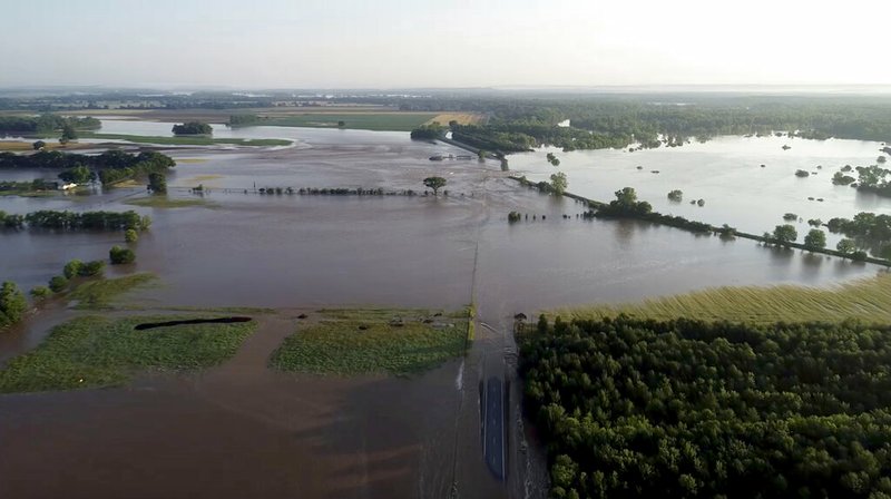 In this aerial image provided by Yell County Sheriff's Department water rushes through the levee along Arkansas River in Dardanelle, Ark., on Friday, May 31, 2019. Officials say the levee breached early Friday at Dardanelle, about 60 miles northwest of Little Rock. (Yell County Sheriff's Department via AP)