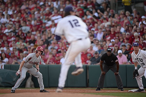 Arkansas outfielder Heston Kjerstad watches as TCU pitcher Nick Lodolo throws a pitch during an NCAA regional game Saturday, June 1, 2019, in Fayetteville. 