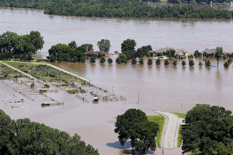 Floodwaters from the Arkansas River spill over the banks near homes and the Pulaski County Garden Center at Two Rivers Park in this Friday, May 31, 2019 file photo. 