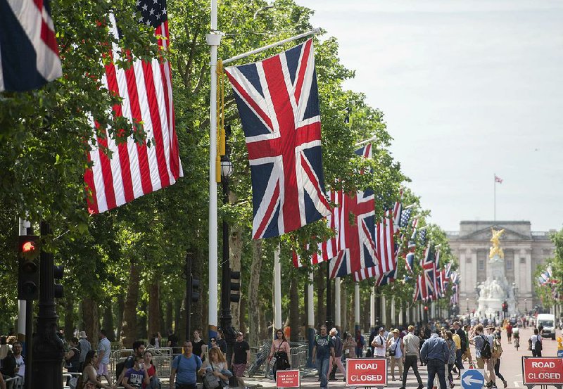 The flags of the United Kingdom and the United States on Sunday line the thoroughfare leading to the Queen Victoria monument in front of Buckingham Palace in London. 