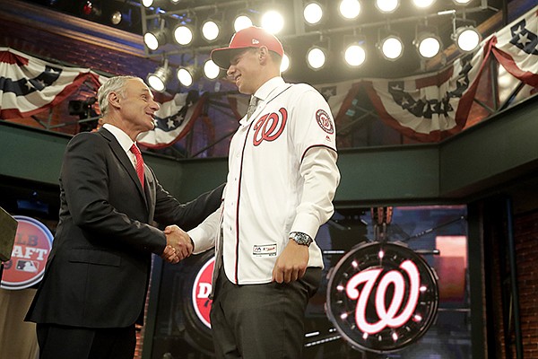 Major League Baseball Commissioner Rob Manfred smiles after