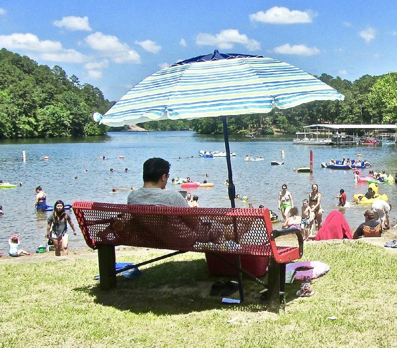 The beach at Lake Catherine State Park is busy on a sunny weekend afternoon. 