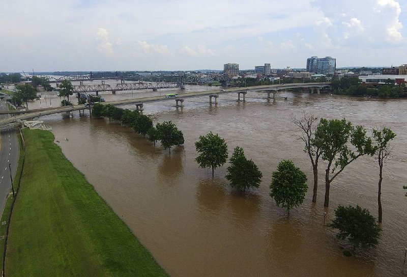 FILE — Floodwaters from the Arkansas River cover areas of downtown North Little Rock (left) and Little Rock in this June 4, 2019, file photo.