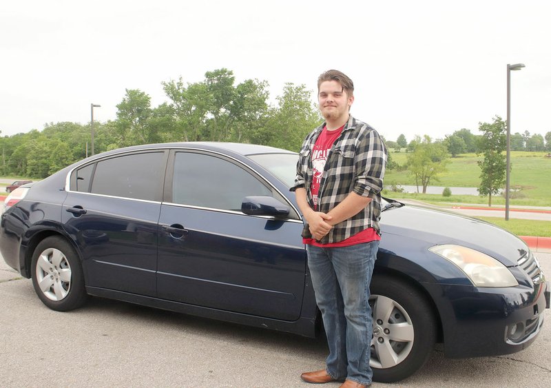 LYNN KUTTER ENTERPRISE-LEADER Colton Hankins, a recent Lincoln High graduate, stands next to his "new" car, a 2007 Nissan Altima. Hankins was the recipient of a new transportation scholarship given by Lincoln High School, with the help of donations from several partners.