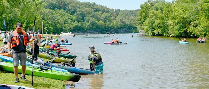 Keith Bryant/The Weekly Vista Staff helped kayak samplers try out a variety of human-powered watercraft during last Saturday's kayak demo, an annual event put on by Ozark Mountain Trading Company.