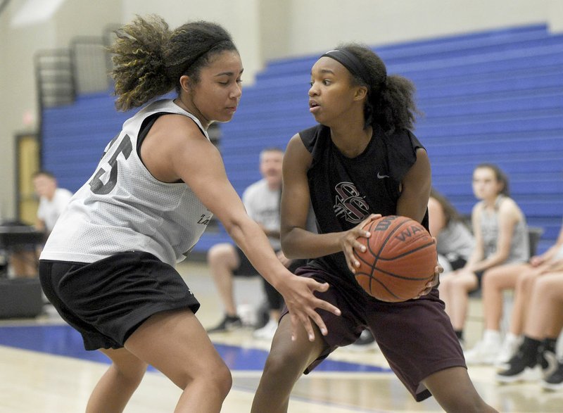 Charlie Kaijo/NWA Democrat-Gazette Rising senior Jael Harried, right, goes up against a Prairie Grove defender during Rogers Team Camp last Friday at W.E. King Arena on the campus of Rogers High School.