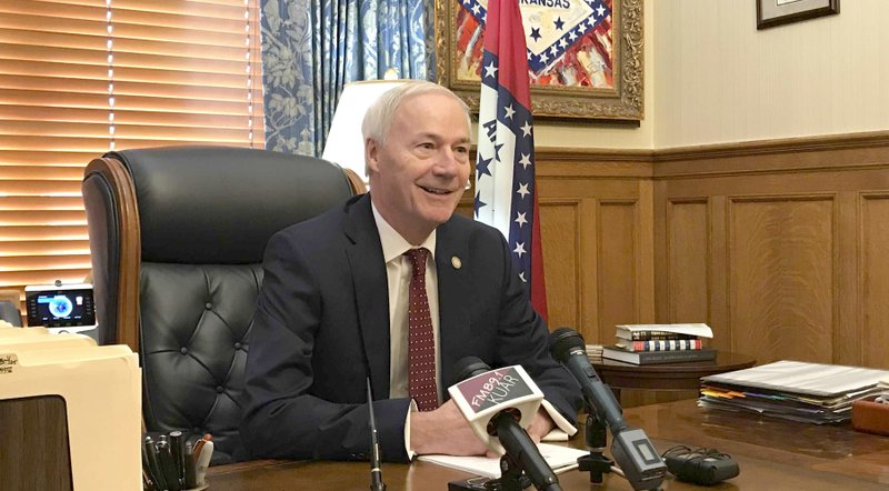 Arkansas Gov. Asa Hutchinson talks to reporters at the state Capitol in Little Rock, Arkansas, Wednesday, May 22, 2019