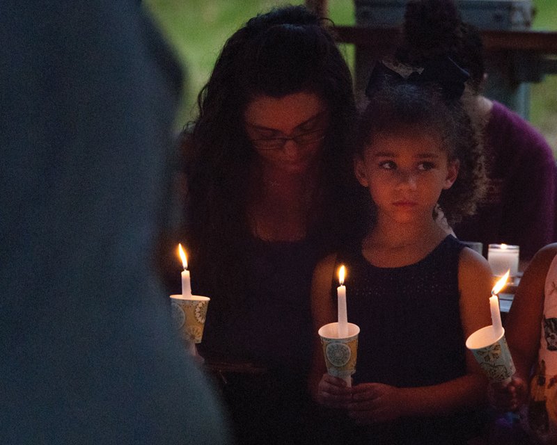 Blakely Matlock attends a candlelight vigil with her mother, Deanna Matlock, in honor of 4-year-old Maleah Davis, whose remains were found last week along Interstate 30 in Hempstead County, 20 miles northeast of Texarkana. (Staff photo by Danielle Dupree)