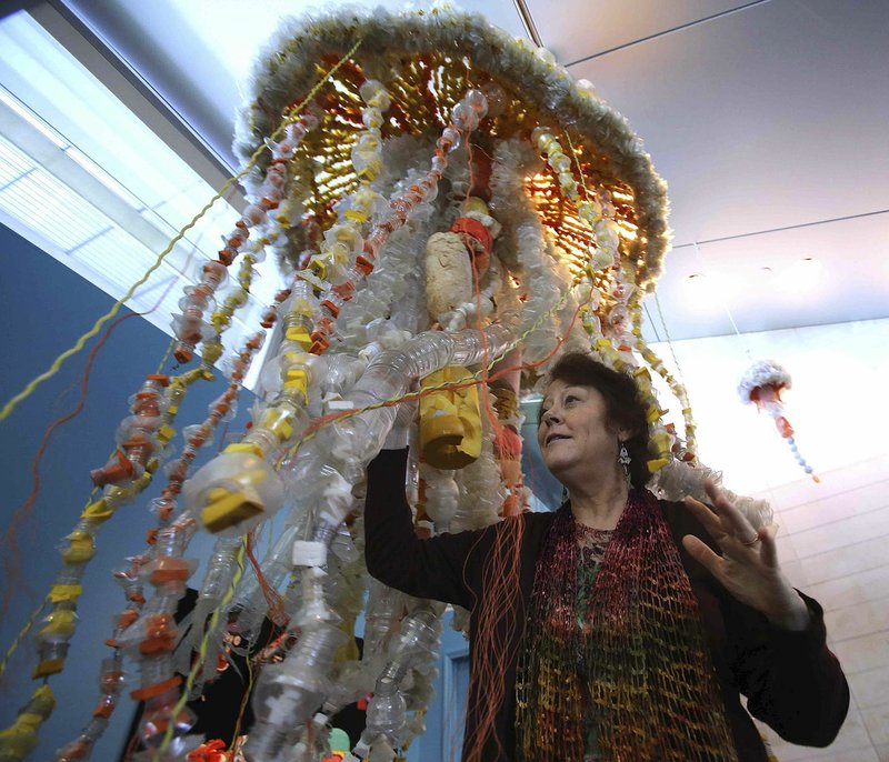 Arkansas Democrat-Gazette/THOMAS METTHE Former art teacher Angela Haseltine Pozzi, creator of the Washed Ashore project, shows off a jellyfish made of junk, mostly plastic bottles that have washed ashore.