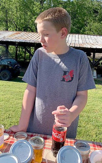 Courtesy photo Keigan Price tries ghost pepper jelly for the first time at the Powell Farmers Market. McKeever Mountain Farms offers a variety of unique jellies at the market. The next Farmers Market will open at 3 p.m. this Friday, June 7. The event is held, rain or shine, with a pavilion available for cover.