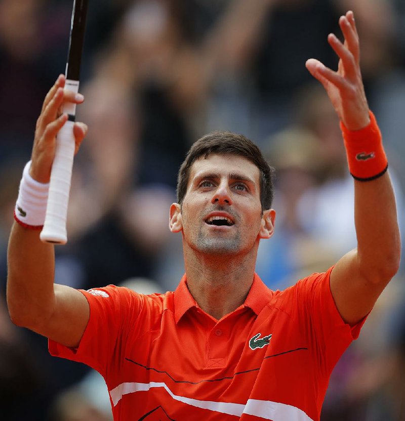 Serbia's Novak Djokovic celebrates winning his quarterfinal match of the French Open tennis tournament against Germany's Alexander Zverev in three sets, 7-5, 6-2, 6-2, at the Roland Garros stadium in Paris, Thursday, June 6, 2019. 