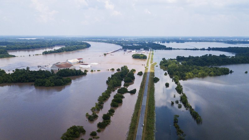 This aerial photo shows flooding along the Arkansas River in Pine Bluff, Ark., Tuesday, June 4, 2019. The economically struggling Arkansas city in the midst of a revitalization plan continued flooding Tuesday as the Arkansas River crested its banks, but local officials said even after the waters recede, the community's resilience will bolster recovery. (DroneBase via AP)