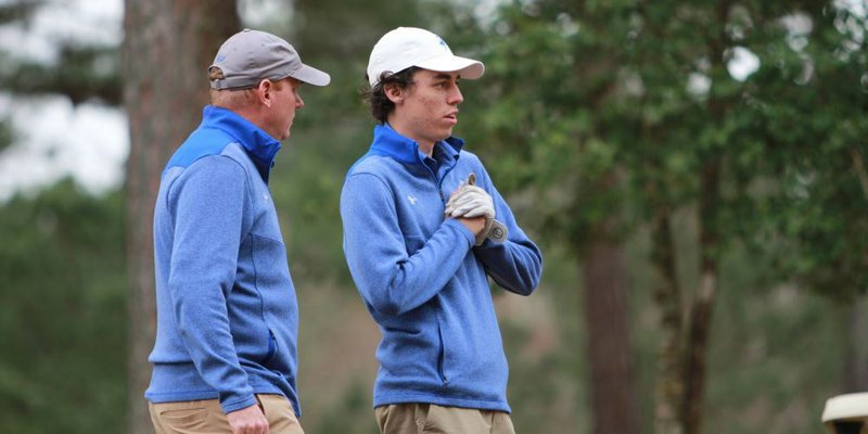 SAU golf coach Ben Sanders (left) visits with Mulerider Kade Johnson during a match this season. A youth golf clinic will start Tuesday at the Magnolia Country Club.