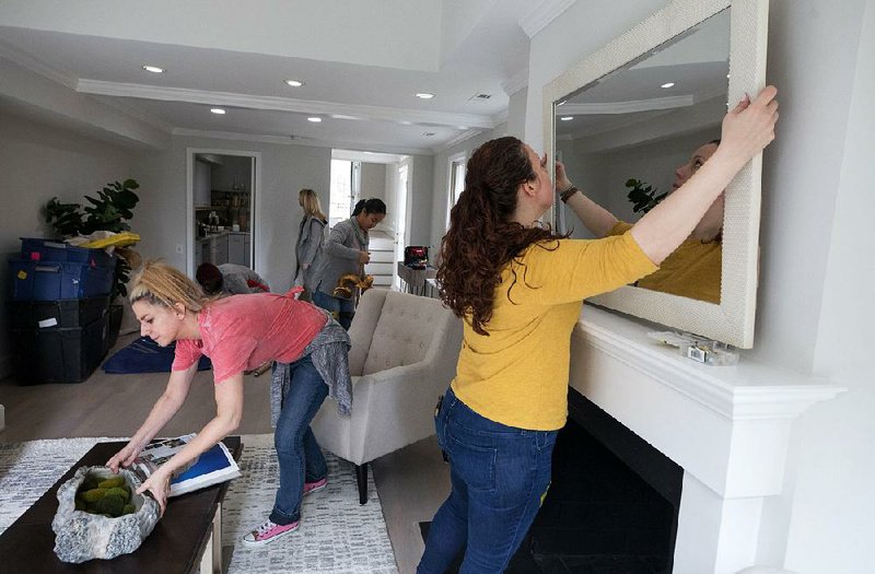 Stagers from Red House Staging and Interiors prepare a house for sale in the District of Columbia.