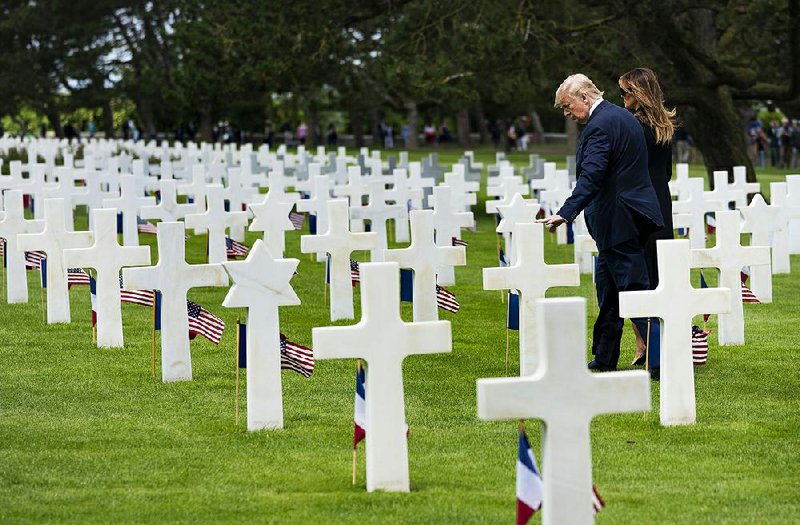 President Donald Trump and his wife, Melania, view the Normandy American Cemetery in Colleville-sur-Mer in France on Thursday during events marking the 75th anniversary of the D-Day invasion. 