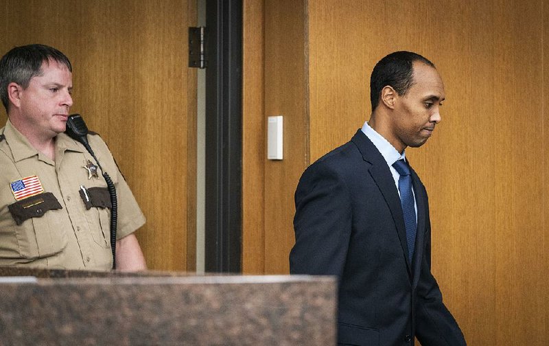Former police officer Mohamed Noor heads into a Minneapolis courtroom Friday for his sentencing in the shooting death of Justine Ruszczyk Damond. 
