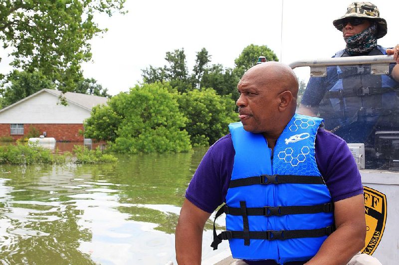 Jefferson County Judge Gerald Robinson is shown in this file photo viewing the flooding at Island Harbor Estates. At right is Courtney Kelly, a marine patrol officer with the sheriff’s office. 
