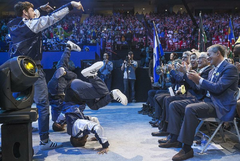 FILE — Dancers perform in front of Walton family members during the 2019 shareholders event.