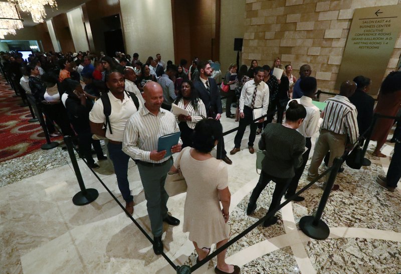 In this Tuesday, June 4, 2019 photo, job applicants line up at the Seminole Hard Rock Hotel & Casino Hollywood during a job fair in Hollywood, Fla. On Friday, June 7, the U.S. government issues the May jobs report. (AP Photo/Wilfredo Lee) story.lead_photo.caption