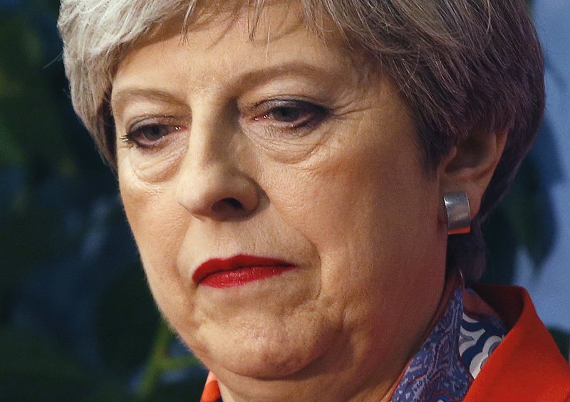 FILE - In this Friday, June 9, 2017 file photo Britain's Prime Minister Theresa May listens as the declaration at her constituency is made for in the general election in Maidenhead, England. A general election called by May to bolster her party's numbers in Parliament to help with the Brexit negotiations backfires as her Conservative Party loses its majority and continues in a weakened state as a minority government.(AP Photo/Alastair Grant, File) story.lead_photo.caption