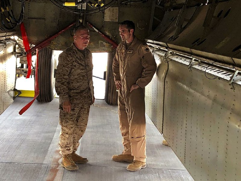 Marine Gen. Frank McKenzie, the head of U.S. Central Command, confers with an Air Force officer below a B-52 bomber Friday at al-Udeid air base in Qatar. 