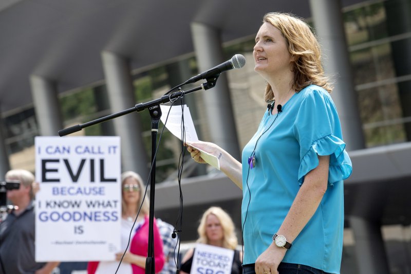 FILE - In this Tuesday, June 12, 2018 file photo, rape survivor and abuse victim advocate Mary DeMuth speaks during a rally protesting the Southern Baptist Convention's treatment of women outside the convention's annual meeting at the Kay Bailey Hutchison Convention Center in Dallas. On Tuesday, June 11, 2019, the Southern Baptist Convention gathers for its annual national meeting with one sobering topic _ sex abuse by clergy and staff _ overshadowing all others. (AP Photo/Jeffrey McWhorter)