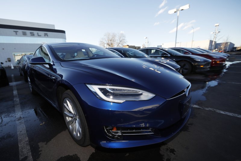 FILE - In this Sunday, Feb. 3, 2019, file photograph, an unsold 2019 S75D sits at a Tesla dealership in Littleton, Colo. Rising trade tensions have sparked worries about the 17 exotic-sounding rare minerals needed for high-tech products like robotics, drones and electric cars. China recently raised tariffs to 25% on rare earth exports to the U.S. and has threatened to halt exports altogether after the Trump administration raised tariffs on Chinese products and blacklisted telecommunications giant Huawei. (AP Photo/David Zalubowski, File) story.lead_photo.caption