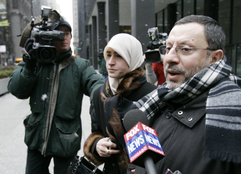 In this Feb. 1, 2007 file photo, Abdelhaleem Ashqar is surrounded by cameramen as he leaves federal court with his wife, in Chicago. Ashquar who says he fears torture at the hands of Israeli authorities, is back in the U.S. after a judge's order forced immigration authorities to reverse his deportation and bring him back from Israel before he ever got off the plane.  (AP Photo/Charles Rex Arbogast)
