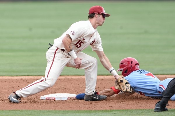 Arkansas Razorbacks infielder Casey Martin (15) attempts to tag Ole Miss infielder Anthony Servideo (3) during game two of the College Baseball Super Regional, Sunday, June 9, 2019 at Baum-Walker Stadium in Fayetteville. Ole Miss forces a game three with a 13-5 win over the Razorbacks