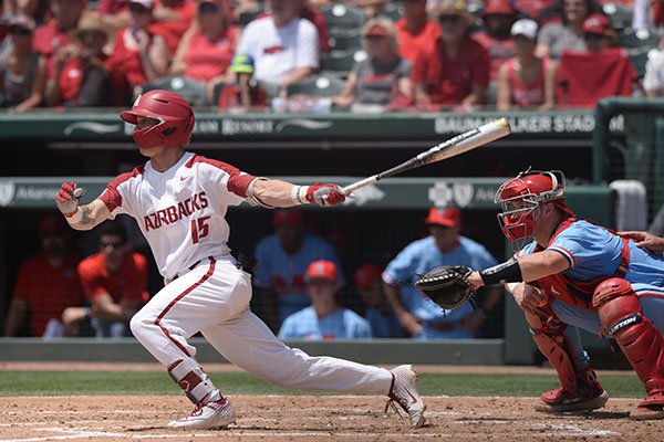 Arkansas shortstop Casey Martin hits a single during the first inning of an NCAA super regional game against Ole Miss on Saturday, June 8, 2019, in Fayetteville.
