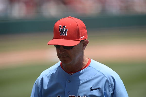 Ole Miss coach Mike Bianco walks toward the dugout during an NCAA super regional game against Arkansas on Saturday, June 8, 2019, in Fayetteville.