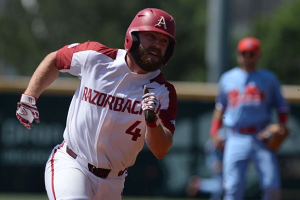 Arkansas first baseman Trevor Ezell runs toward third base during the first inning of an NCAA super regional game against Ole Miss on Saturday, June 8, 2019, in Fayetteville.