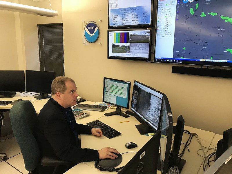 Christopher C. Buonanno, science and operations officer at the National Weather Service’s office in North Little Rock, checks a satellite image that depicts the temperature of clouds across Arkansas. The agency for nearly three weeks has juggled its daily operations and its coverage of flooding on the Arkansas River. 