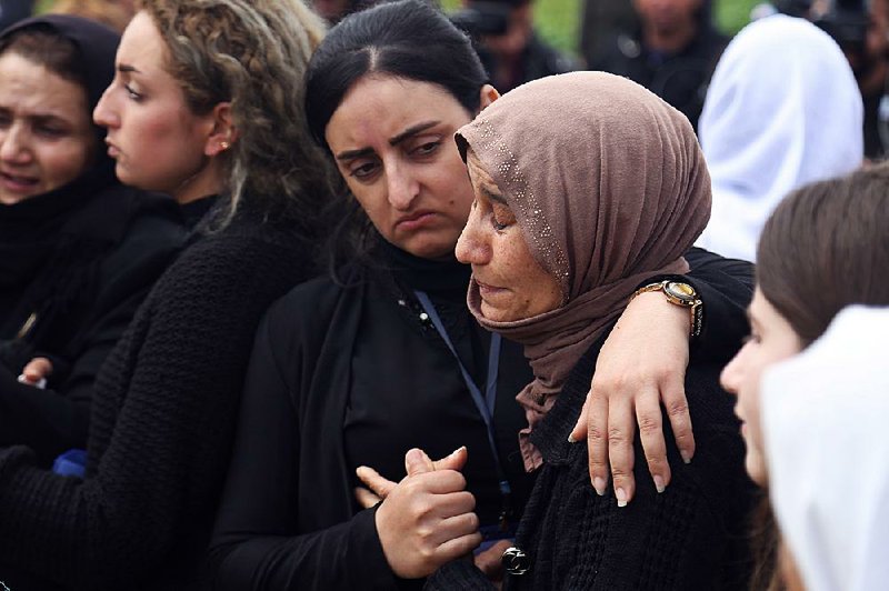 Yazidis mourn during the March exhumation of a mass grave in Iraq’s Sinjar region. 