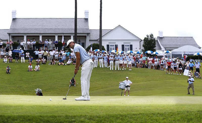 International team member Luis Gagne putts on the 18th hole during his match against John Augenstein of the United States while the gallery watches. Matt Fraser, head professional at the Alotian Club, said close to 1,000 tickets were sold for the Arnold Palmer Cup, and he estimated that close to 2,000 fans were on the course Saturday for the mixed foursomes and foursome sessions.