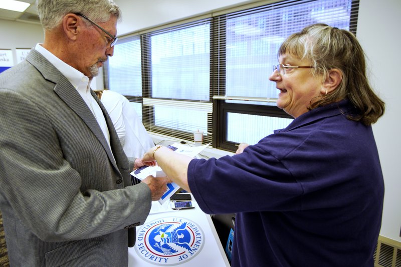 In this April 25, 2019 photo, FEMA representative Kristina Pooler, right, talks to Ned Holmes, National Guard Employment Support specialist, about available FEMA jobs, at a job fair in Lincoln, Neb. With federal disaster recovery staffers scrambling to meet needs amid floods, hurricanes and fires, they are now dealing with another issue _ historically low unemployment that's hampering their efforts to hire workers to help with the calamities. (AP Photo/Nati Harnik) story.lead_photo.caption