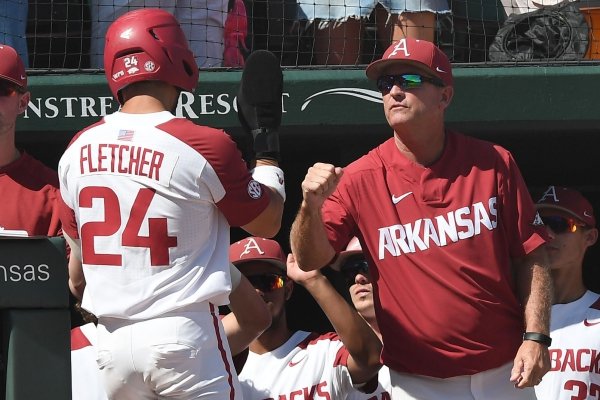 Arkansas' coach Dave Van Horn congratulates Dominic Fletcher on his score in the bottom of the third inning against Ole Miss Monday June 10, 2019 during the NCAA Fayetteville Super Regional at Baum-Walker Stadium in Fayetteville. Arkansas won 14-1 and will advance to the College World Series in Omaha.