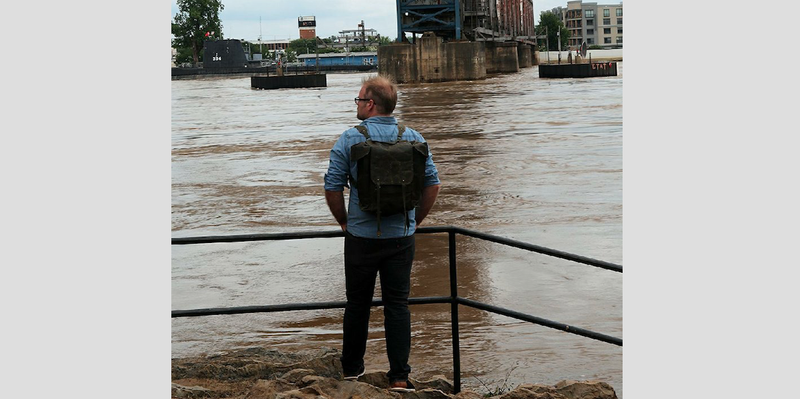 Josh Vanwie of Denver watches the Arkansas River on Sunday from Riverfront Park in downtown Little Rock. 