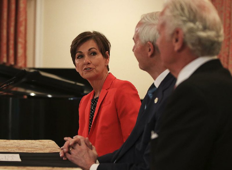 Gov. Kim Reynolds (from left) of Iowa, joined by counterparts Asa Hutchinson of Arkansas and Henry McMaster of South Carolina, speaks Monday at a news conference during the National Computer Science Summit for State Leaders, held at the Governor’s Mansion in Little Rock. 