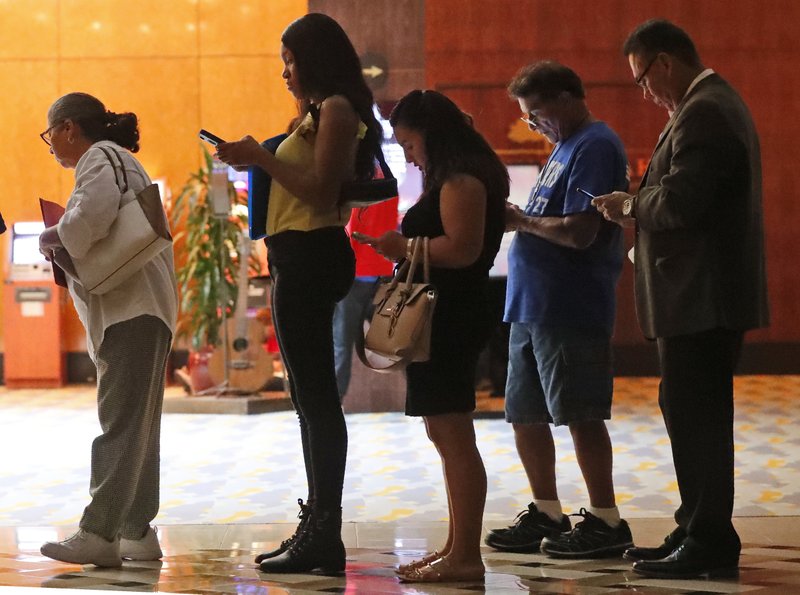 In this Tuesday, June 4, 2019 photo, job applicants wait in line at the Seminole Hard Rock Hotel &amp; Casino Hollywood during a job fair in Hollywood, Fla. On Monday, June 10, the Labor Department reports on job openings and labor turnover for April. (AP Photo/Wilfredo Lee)