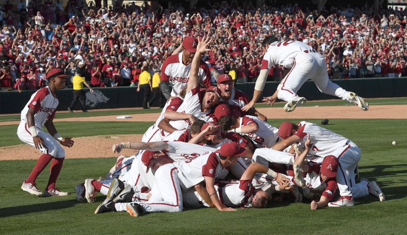 NWA Democrat-Gazette/J.T. Wampler HOG PILE: The Arkansas baseball team celebrates beating Ole Miss Monday during the NCAA Fayetteville Super Regional at Baum-Walker Stadium in Fayetteville. Arkansas won 14-1 and will advance to the College World Series in Omaha. story.lead_photo.caption