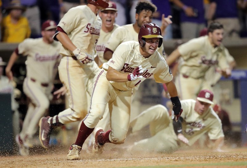 Florida State's Mike Salvatore reacts after crossing home plate to score the winning run against LSU in the 12th inning of Game 2 of the NCAA college baseball super regional tournament in Baton Rouge, La., Sunday, June 9, 2019. Florida State won 5-4 to advance to the College World Series. (AP Photo/Gerald Herbert)