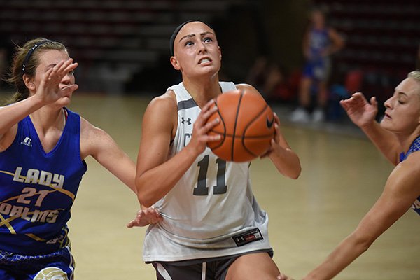 Rylee Langerman, a senior at Christian Heritage High School in Dell City, Okla., drives to the basket Tuesday, June 11, 2019, during the Arkansas women's team camp at Bud Walton Arena on the campus of the University of Arkansas in Fayetteville.
