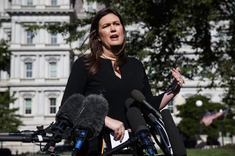 White House press secretary Sarah Sanders talks with reporters outside the White House, Tuesday, June 11, 2019, in Washington. (AP Photo/Evan Vucci)

