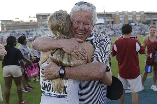 Arkansas' Payton Chadwick is hugged by coach Lance Harter, right, after the team won the women's NCAA outdoor track and field championships in Austin, Texas, Saturday, June 8, 2019. (AP Photo/Eric Gay)