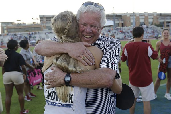 Arkansas' Payton Chadwick is hugged by coach Lance Harter, right, after the team won the women's NCAA outdoor track and field championships in Austin, Texas, Saturday, June 8, 2019. (AP Photo/Eric Gay)

