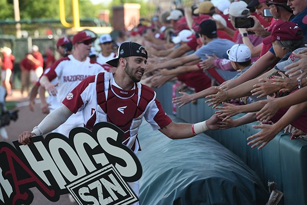 Arkansas catcher Casey Opitz greets fans following the Razorbacks' 14-1 victory over Ole Miss in the NCAA super regional on Monday, June 10, 2019, at Baum-Walker Stadium in Fayetteville.