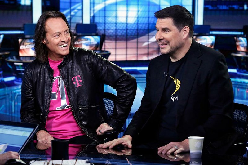 T-Mobile Chief Executive Officer John Legere (left) and then-Sprint CEO Marcelo Claure are shown during an April 2018 interview on the Fox Business Network in New York. 